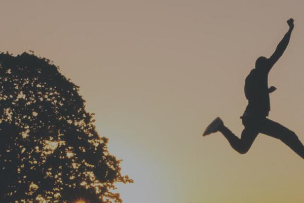 Man leaping over a canyon