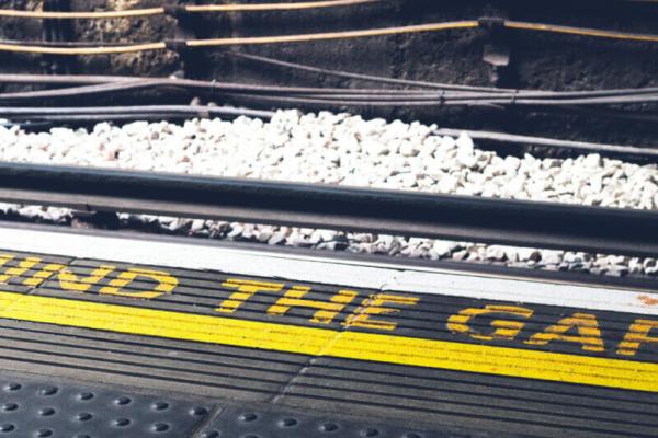 "Mind the Gap" warning painted in yellow on the ground at the London Underground